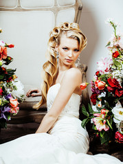 beauty young blond woman bride alone in luxury vintage interior with a lot of flowers 