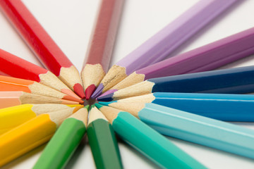 Naklejka premium A group of pencils folded in rainbow colors in a circle on a white background