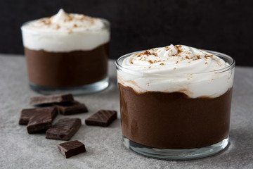 Chocolate mousse with cream on gray stone
