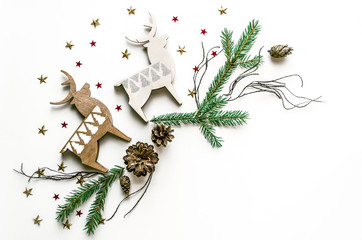 Christmas composition with deer, stars and fir branches. New Year background for presentation of work or text. Beautiful greeting card. Copy space.Top view