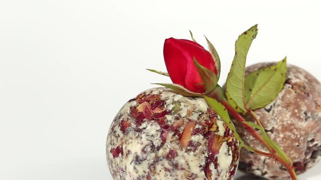 Bath Truffle  with  small pink roses on a light background. vegan cosmetics for body and bath