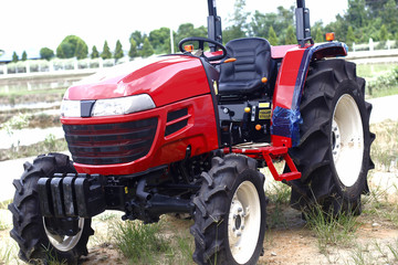 Obraz premium New red agricultural tractor