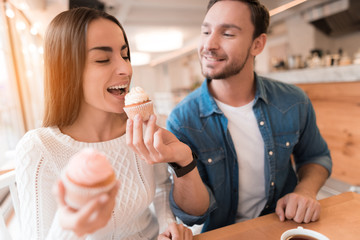 A guy and a girl are sitting together in a cafe.