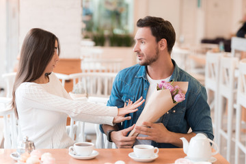 The girl refuses the flowers, which she gives a guy.