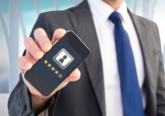 Rating review stars on phone in man's hand