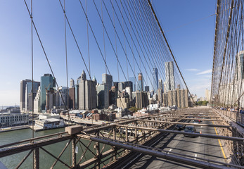 people cross famous Brooklyn Bridge in New York