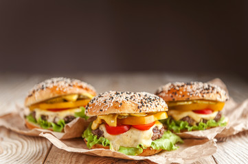 delicious juicy home burger. roll, bagel, with a juicy cutlet from beef, sauces cheese fresh lettuce leaves