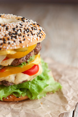 delicious juicy home burger. roll, bagel, with a juicy cutlet from beef, sauces cheese fresh lettuce leaves