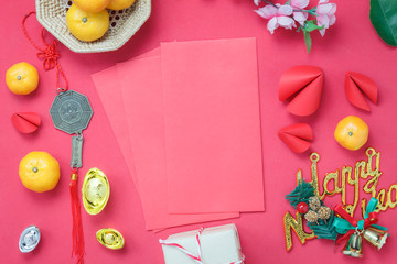 Arrangement decorations Chinese new year & lunar holiday background concept.Beautiful red envelope & ornaments DIY paper fortune cookies on modern rustic wood wallpaper at home office desk studio.