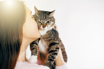 girl kisses a beautiful cat, beautiful girl hugs a cat, girl holding a cat, gentle picture of a beautiful cat and girl