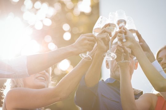 Friends toasting glasses of champagne in balcony