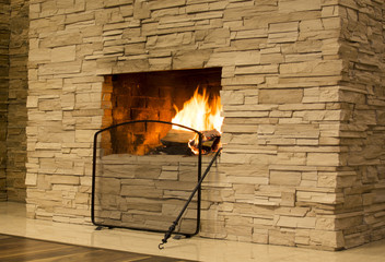 Burning wood in stone fireplace