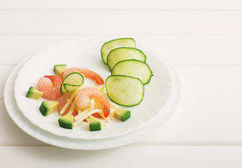 shrimp salad and avocado on a white wooden table
