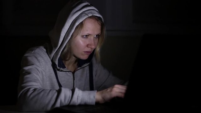 Woman hacker with laptop.