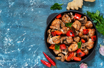 Chicken with mushrooms and bell pepper on a blue concrete background!