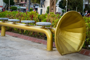 Alania, Turkey, 10.14.2017: The bench in the city park in the form of a wind pipe.