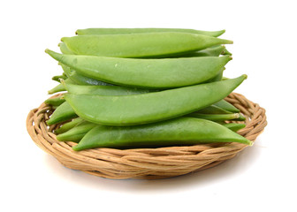Pods of green peas sweet, isolated in basket on a white background