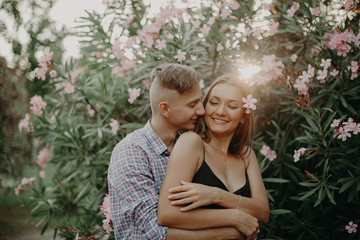 Young Sweet Couple in Tropical Nature. Two beautiful Hipsters Couple in Love. The Guy and the Girl Have Fun at Valentines Day. Film Effects, Toning and Color