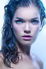Woman with blue eyes and wet hair. Beauty portrait