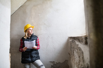 Young woman worker on the building site.