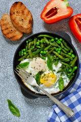 Homemade light breakfast. Scrambled eggs with asparagus and green peas. Crispy baguette grill.