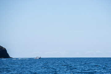 Fototapeta premium Small sportboat on atlantic ocean for island