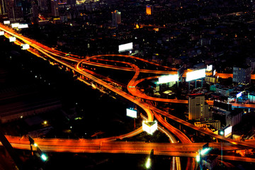City in the night with the express way and sign board in Bangkok,Thailand.