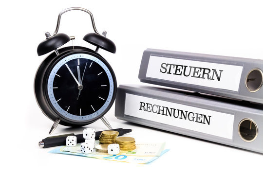 File folders and alarm clock symbolize time pressure. Translation: "Taxes" and "Bills"