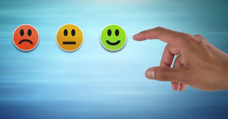 Hand pointing at smiley faces feedback satisfaction icons