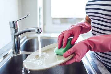 Young woman is doing cleaning at home