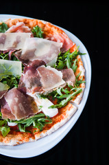 Italian pizza slice pamaham arugula and margarita sauce in vertical top angle shot