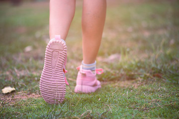 Close-up to sports shoes woman legs in walking movement.