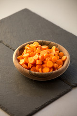 Carrot slices in wooden bowl.