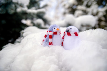 Two decorative penguins sit on the snow