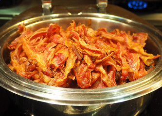 Fried bacon strips in a bowl