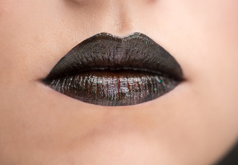 Naklejka premium Lips painted with black lipstick