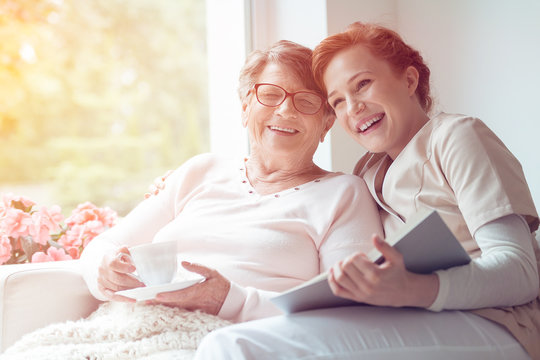 Caregiver and senior woman laughing