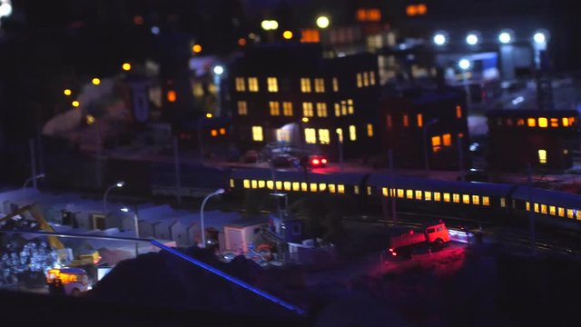 Train at night through the city with lights bokeh in slow motion. 3840x2160