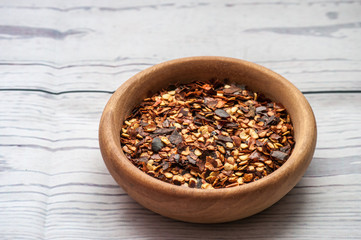 dried chilli and powder chilli on wooden table