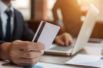 businessman holding credit card and using laptop computer. Online shopping concept