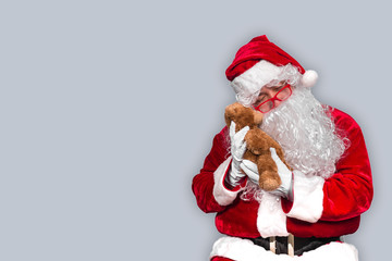 Santa claus have a teddy for children,merry christmas,Gifts for Children,Portrait of santa claus on white background,December is the month of Christmas.