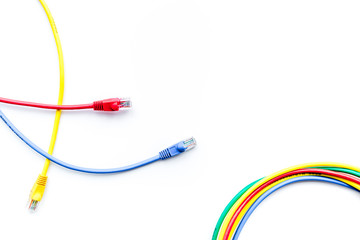 Colored patch-cord on white background top view copyspace