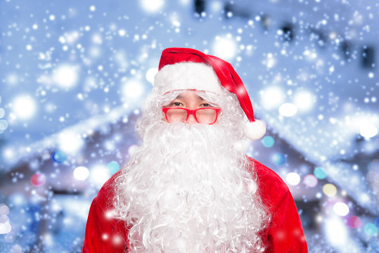 Asian santa claus on blurry christmas with snow background,Happy merry christmas