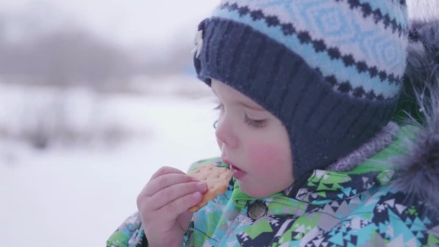 the child eats cookies winter outdoor