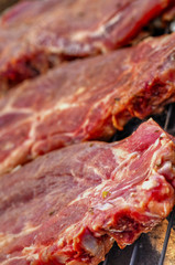 Baking fresh meat on grill closeup