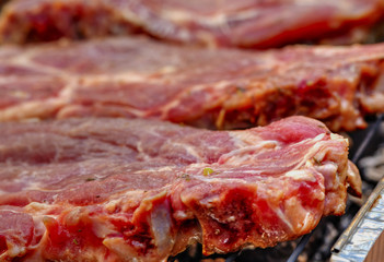 Baking fresh meat on grill closeup