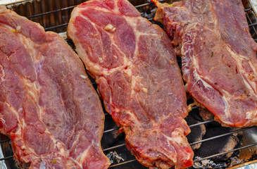 Baking fresh meat on grill closeup