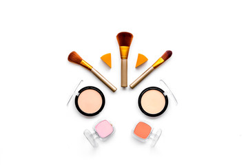 Decorative cosmetics pattern. Eyeshadows, rouge, brushes on white background top view