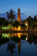 Tran Quoc Pagoda the oldest Buddhist temple in Hanoi, Vietnam. Located on a small island in West Lake during blue hour