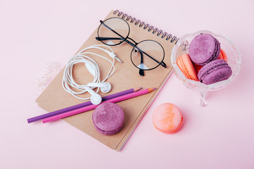 Office supplies for young woman. Flatlay with blanknote, pencils and cookies.